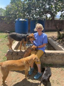 Deborah with four dogs around her